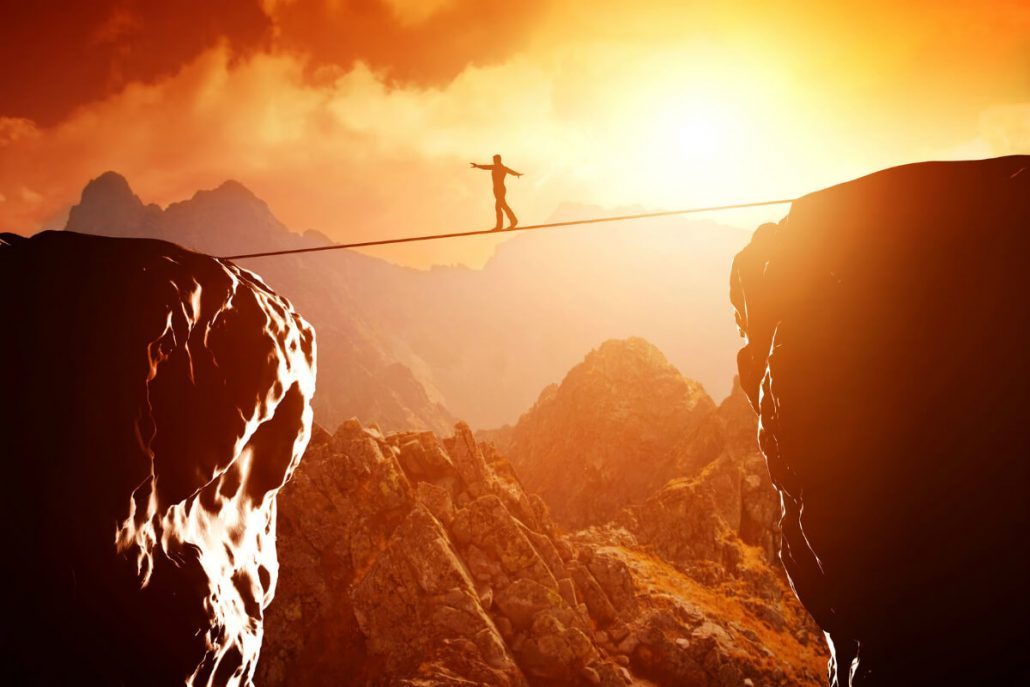 men on a rope over a clif - comfort zone