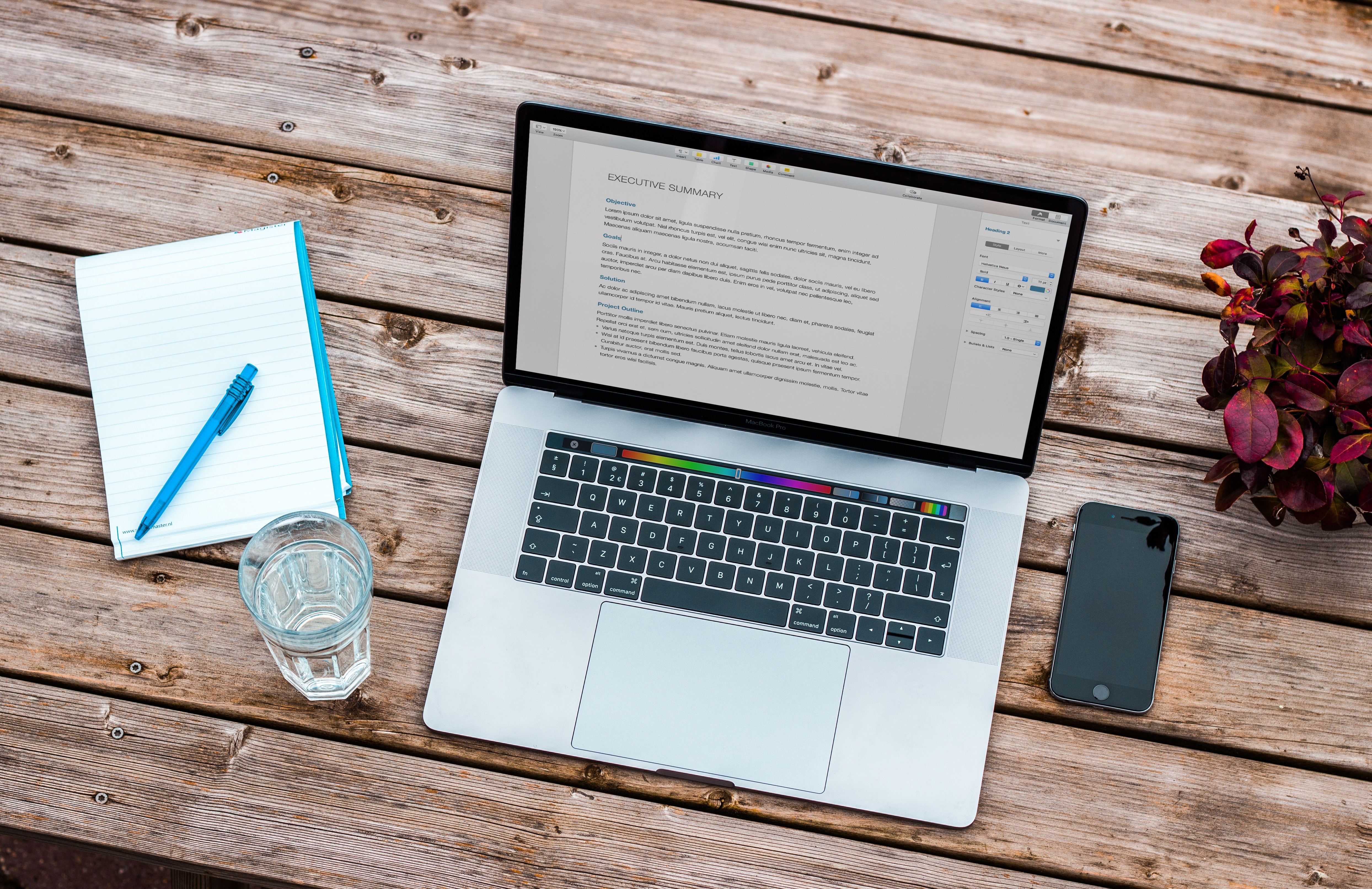 macbook with a resume being written