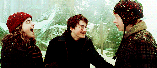 Harry Ron and Hermione laughing in the snow