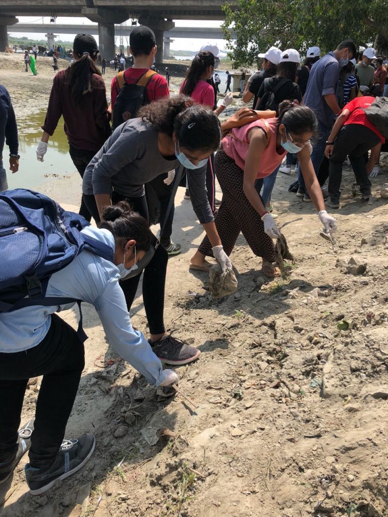girls cleaning the street on world cleanup day