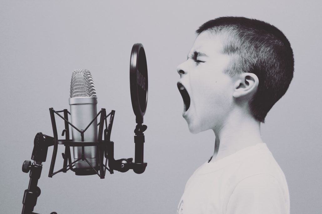 boy speaking in front of the microphone