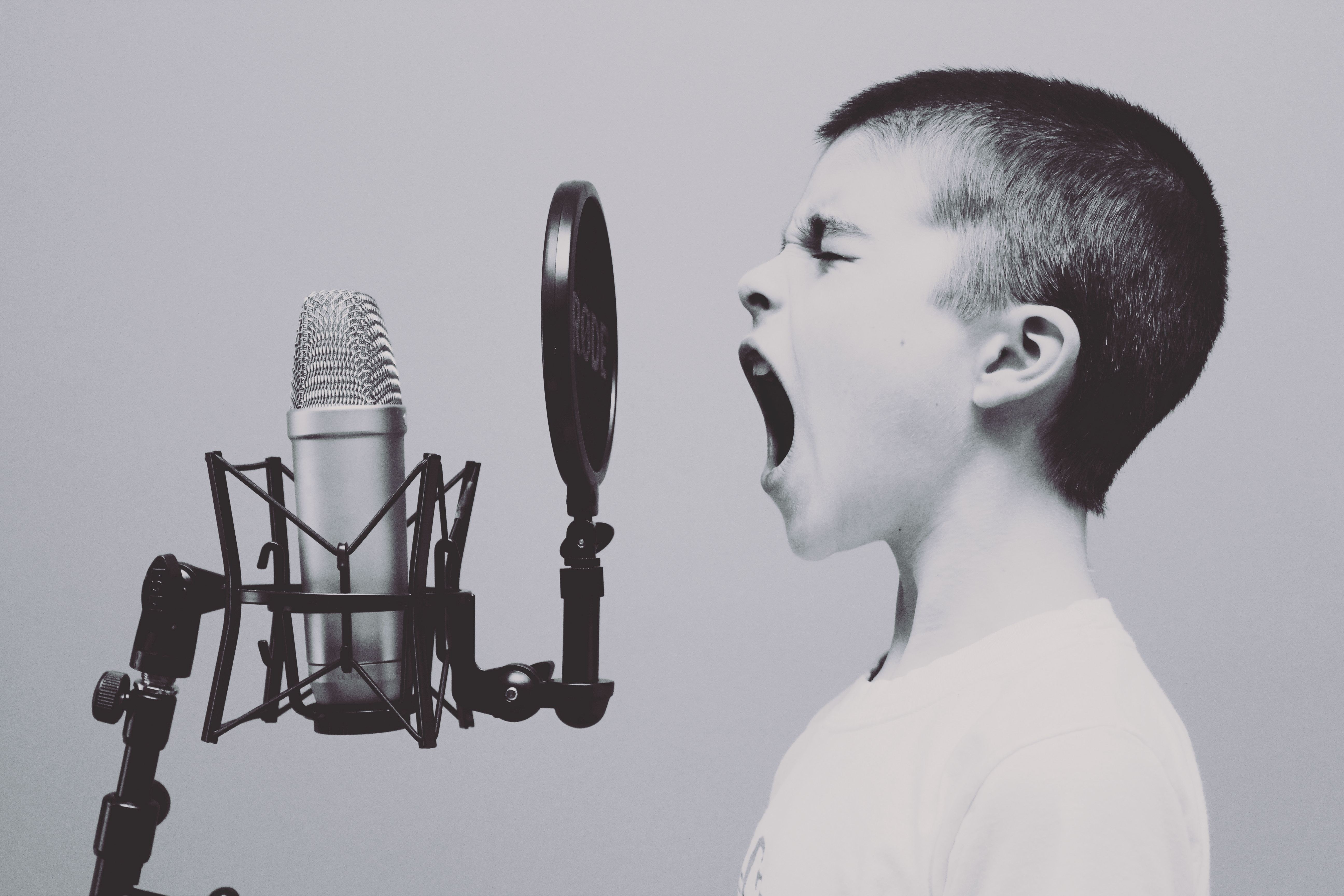 boy speaking in front of the microphone