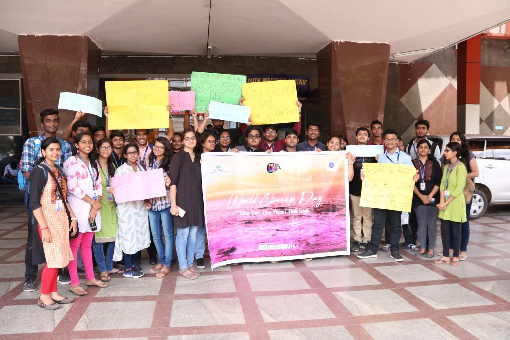 people holding the poster of world cleanup day