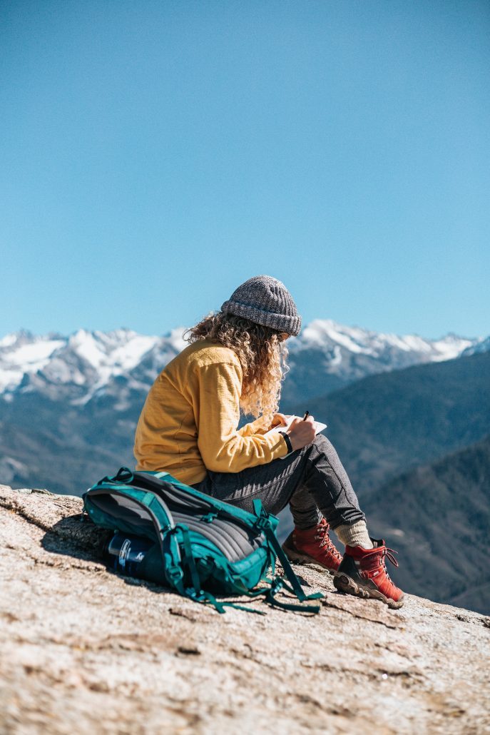 girl writing on a landscape - career out of the box